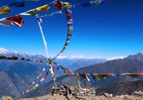 The prayer flags with panorama of Himalayas at the trail to Gosainkunda