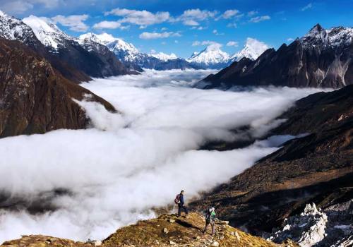 Trekker on the way to the valley covered with cloud on Manaslu trek.